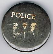 File:1979 09 Police fin costello black background larger round button.jpg