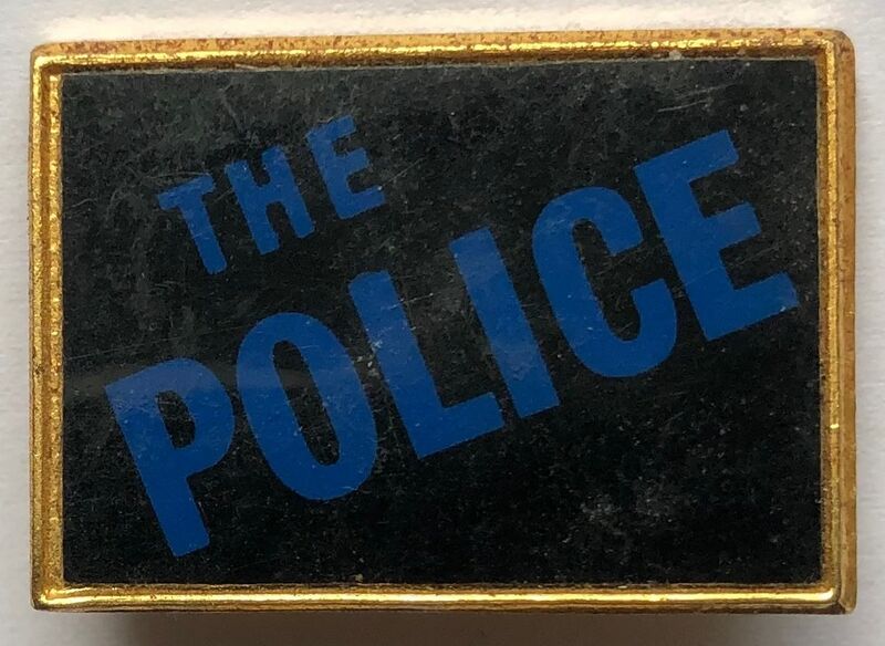 File:The Police square metal badge dark golden frame blue logo.jpg
