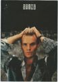Sting grey jacket hands head.jpg