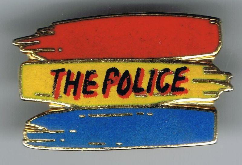 File:Synchronicity colours on metal button.jpg