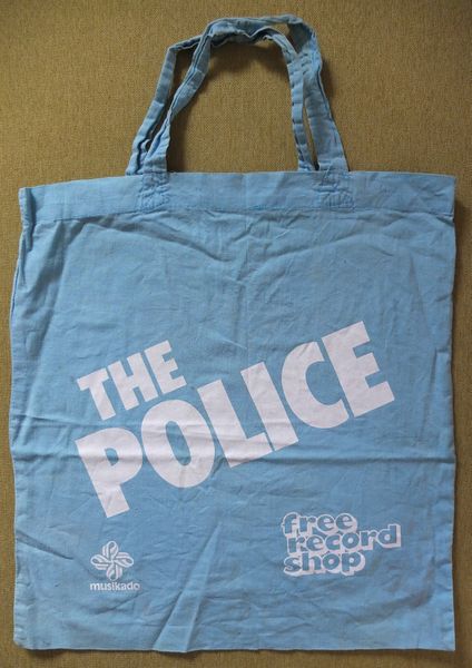File:The Police cloth bag white on bluee.jpg