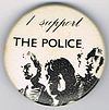 1979 09 Police fin costello white background large round button.jpg