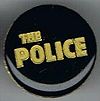 The Police round metal badge golden logo.jpg