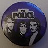 1979 08 Police blue white black button Toni Carbo.jpg