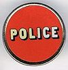 Police round metal badge red.jpg