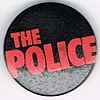 The Police small round button original logo red on black.jpg
